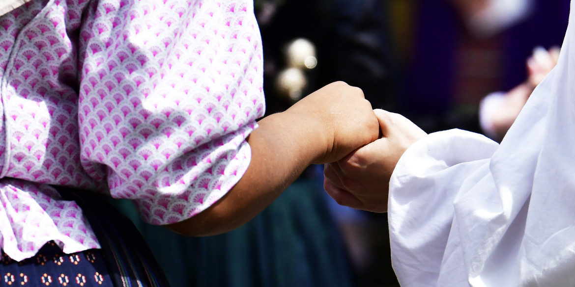 Zwei Trahctenträgerinnen halten sich an den Händen